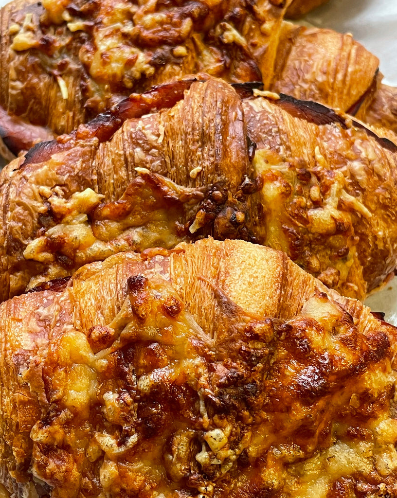 up close photo of twice baked ham and cheese croissants