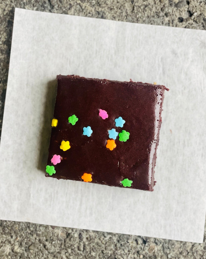photo of an iced brownie with daisy sprinkles