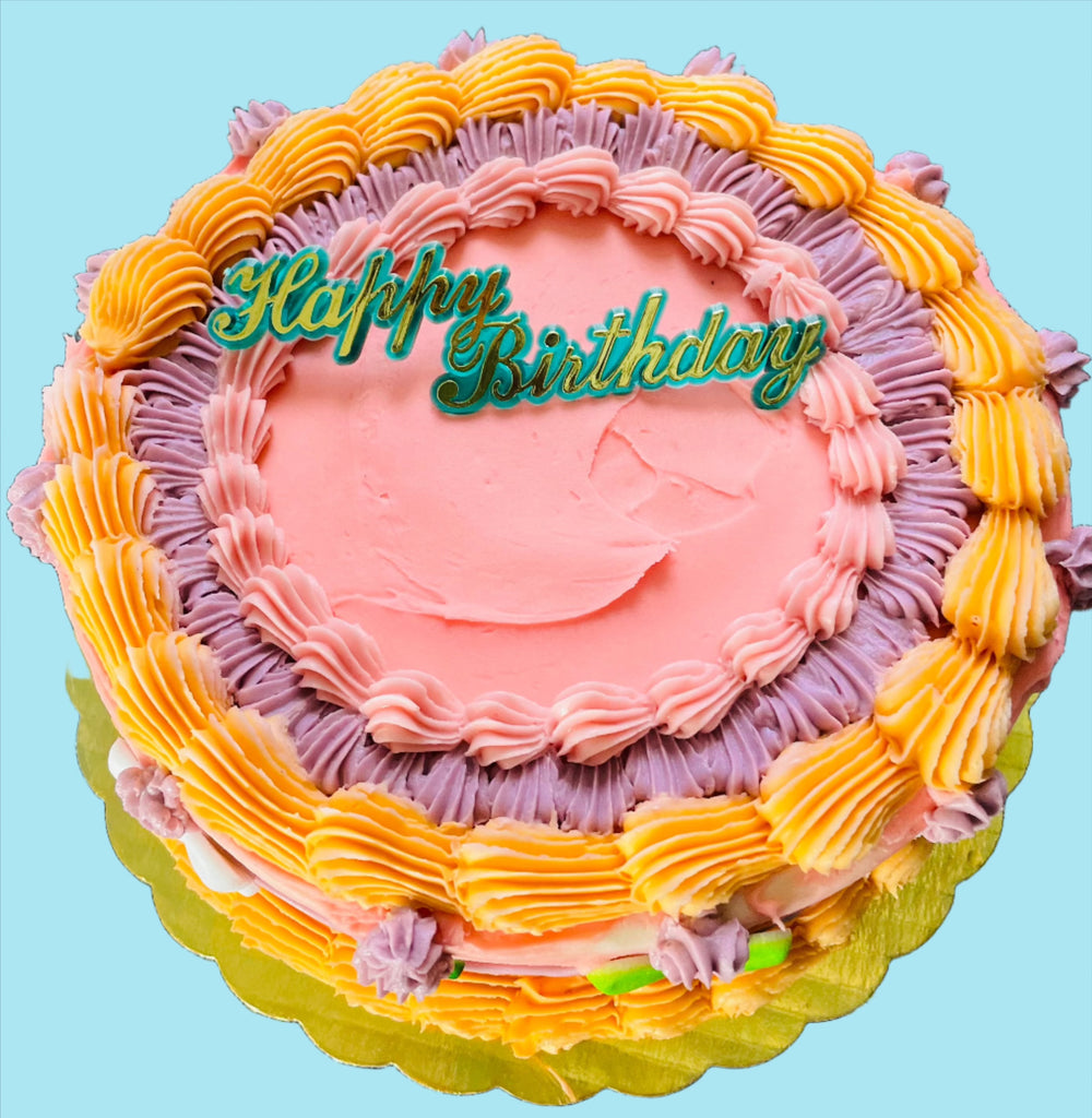 ornate birthday cake with a plastic plaque