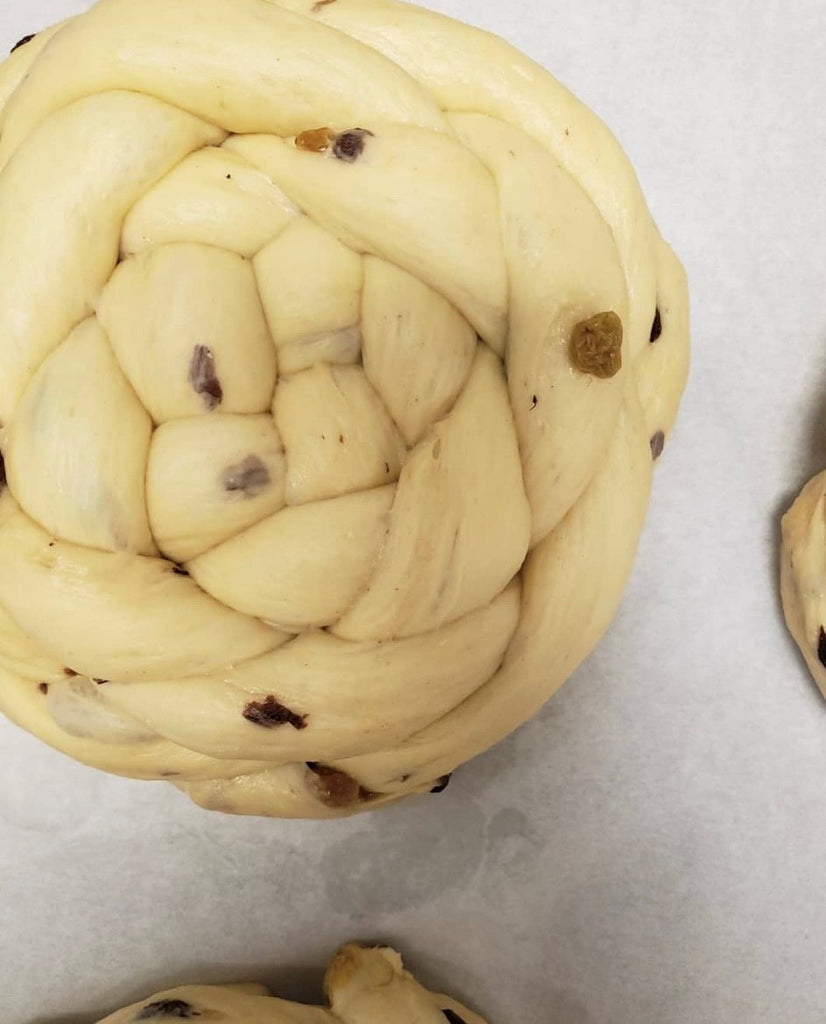 photo of a pre baked round challah.